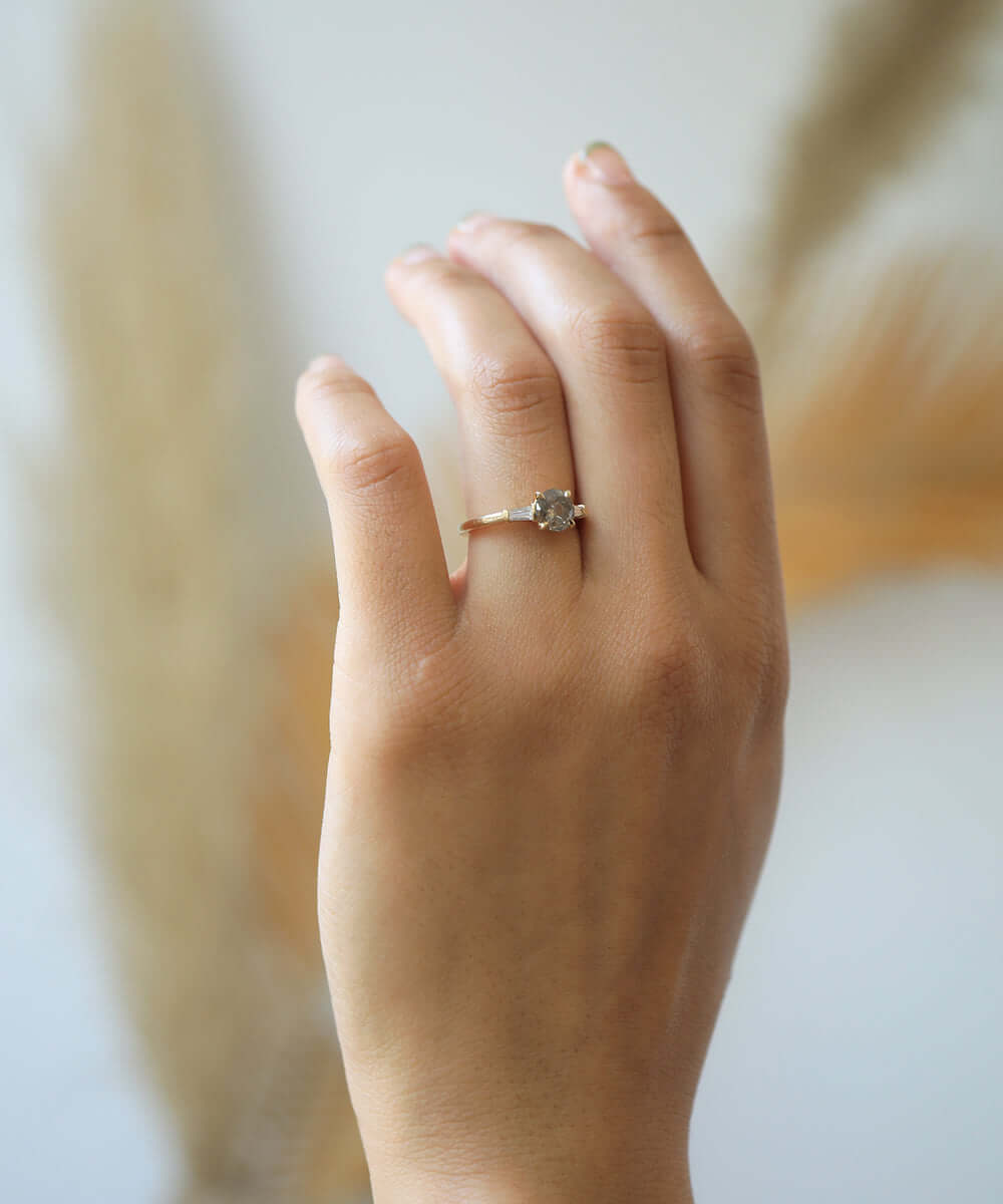 semi-translucent salt n pepper diamond engagement ring accented by white tapered baguettes set in 14k gold band macha studio brooklyn new york
