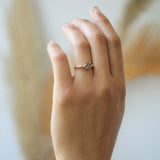 semi-translucent salt n pepper diamond engagement ring accented by white tapered baguettes set in 14k gold band macha studio brooklyn new york