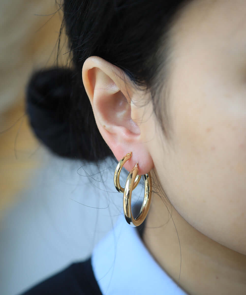 Medium lightweight 14k gold hoops earrings NYC fine jewelry brooklyn NY New York jeweler sustainable ethical greenpoint engagement