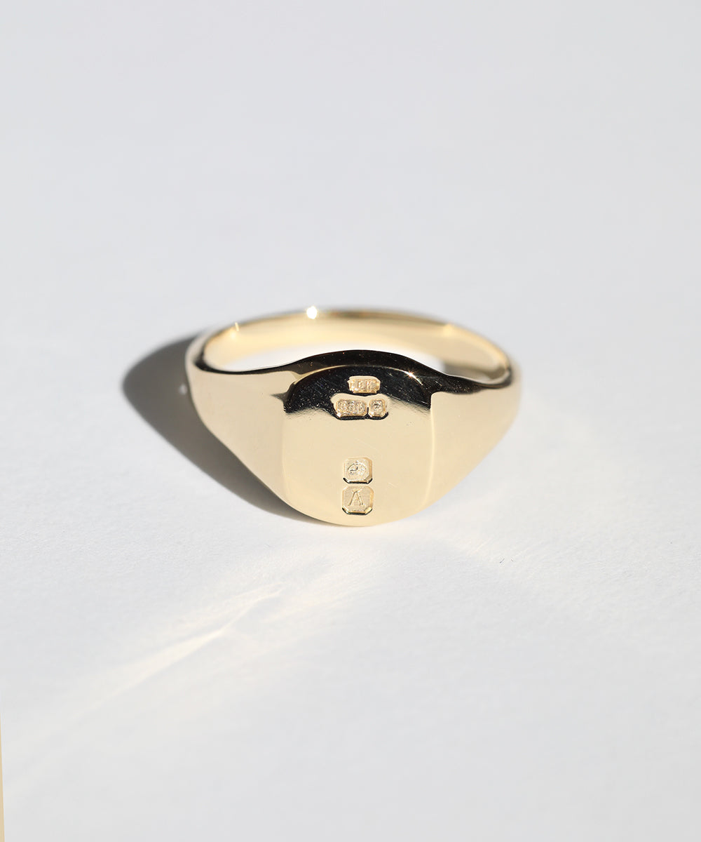 small 14k yellow gold signet ring with rounded square face featuring British hallmarks and date letter 'a' handcrafted macha studio brooklyn new york