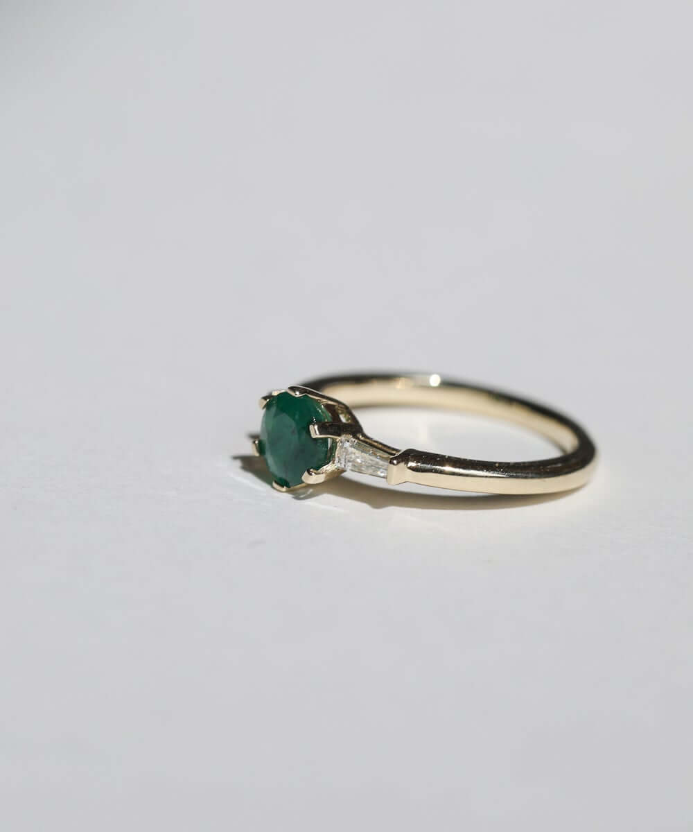 Round cut emerald engagement ring 14k yellow gold white baguette diamonds handcrafted macha studio brooklyn new york