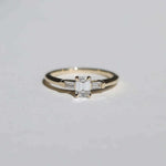 Emerald cut 0.5ct white diamond, with white diamond baguettes set in 14k yellow gold
