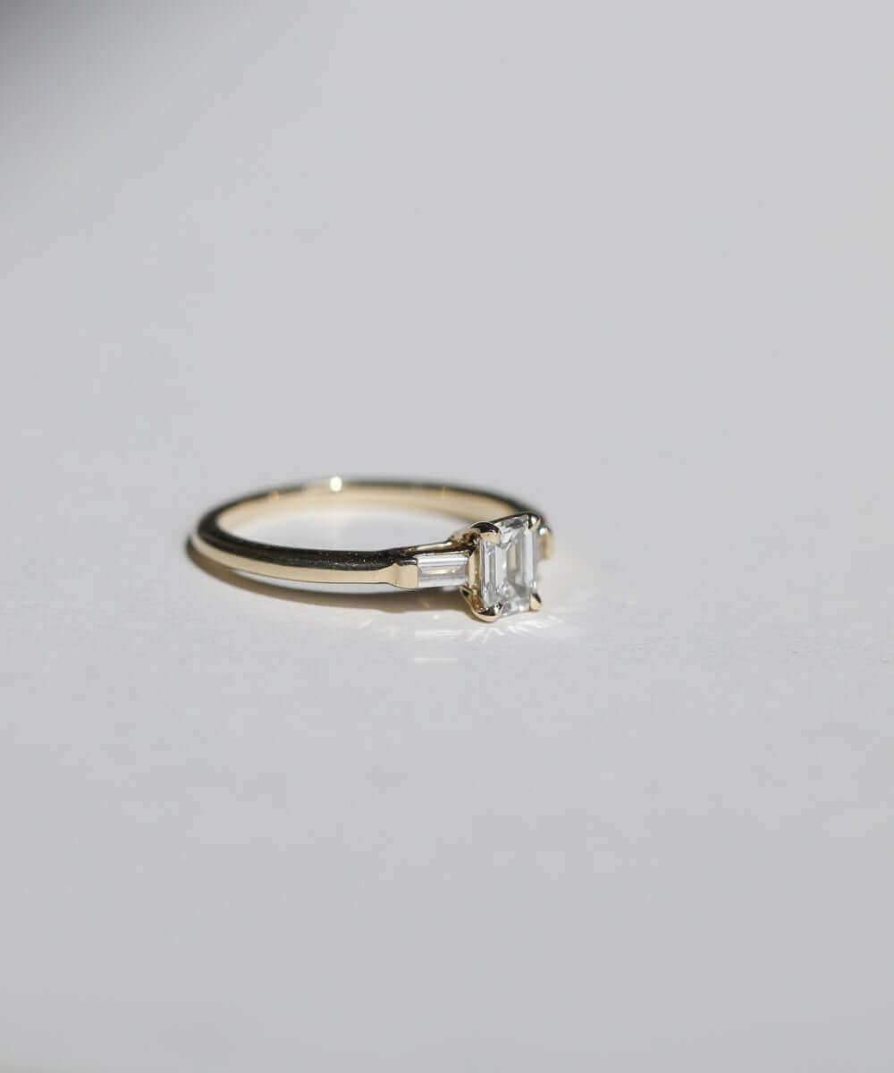 Emerald cut 0.5ct white diamond, with white diamond baguettes set in 14k yellow gold