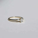Emerald cut 0.5ct white diamond, with white diamond baguettes set in 14k yellow gold