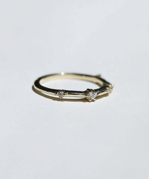 thin 14k yellow gold band with scattered tiny accent white diamonds handcrafted macha studio brooklyn new york