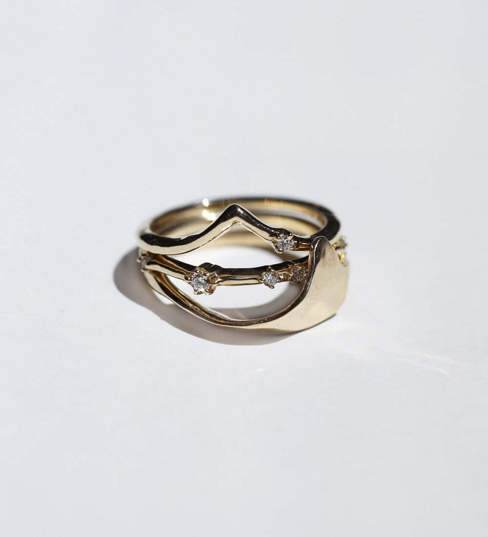 thin 14k yellow gold band with scattered tiny accent white diamonds handcrafted macha studio brooklyn new york