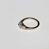 handcrafted white diamond engagement ring featuring large cushion cut center stone accented with two pear shaped stones set in 14k yellow gold band macha studio brooklyn new york
