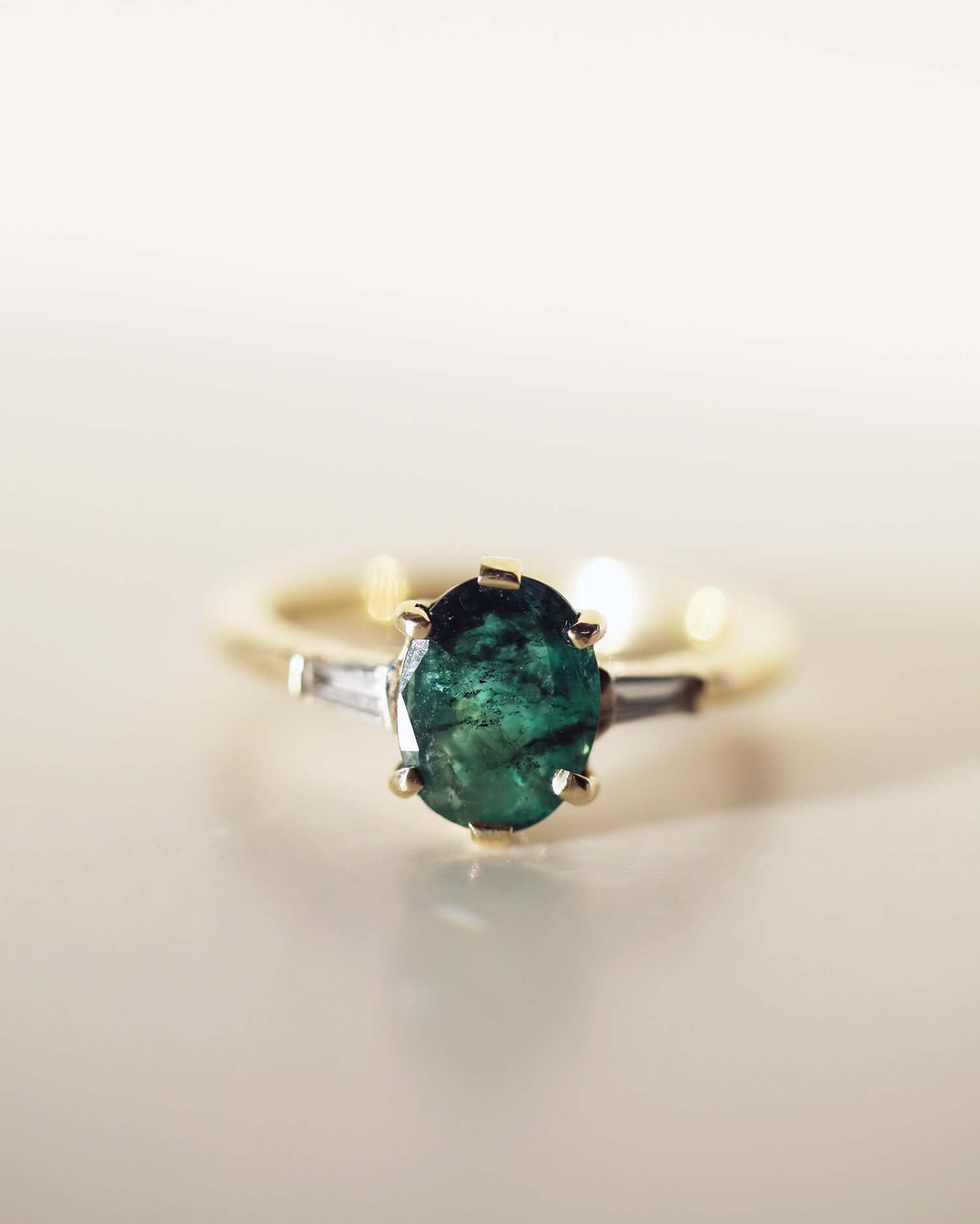 Oval Emerald engagement ring set in gold, by Macha Studio, Brooklyn NYC