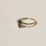 marquise cut salt and pepper diamond with dark warm tones, accented by white diamonds, set in 14k yellow gold