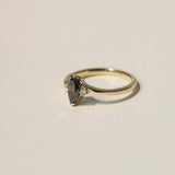 marquise cut salt and pepper diamond with dark warm tones, accented by white diamonds, set in 14k yellow gold