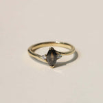 marquise cut salt and pepper diamond with dark warm tones, accented by white diamonds, set in 14k yellow gold