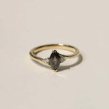 marquise cut salt and pepper diamond with dark warm tones, accented by white diamonds, set in 14k yellow gold