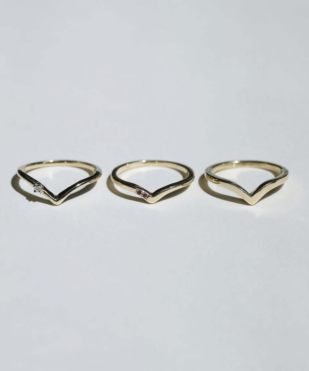 assorted v shaped bands 14k yellow gold diamonds rubies handcrafted macha studio brooklyn new york