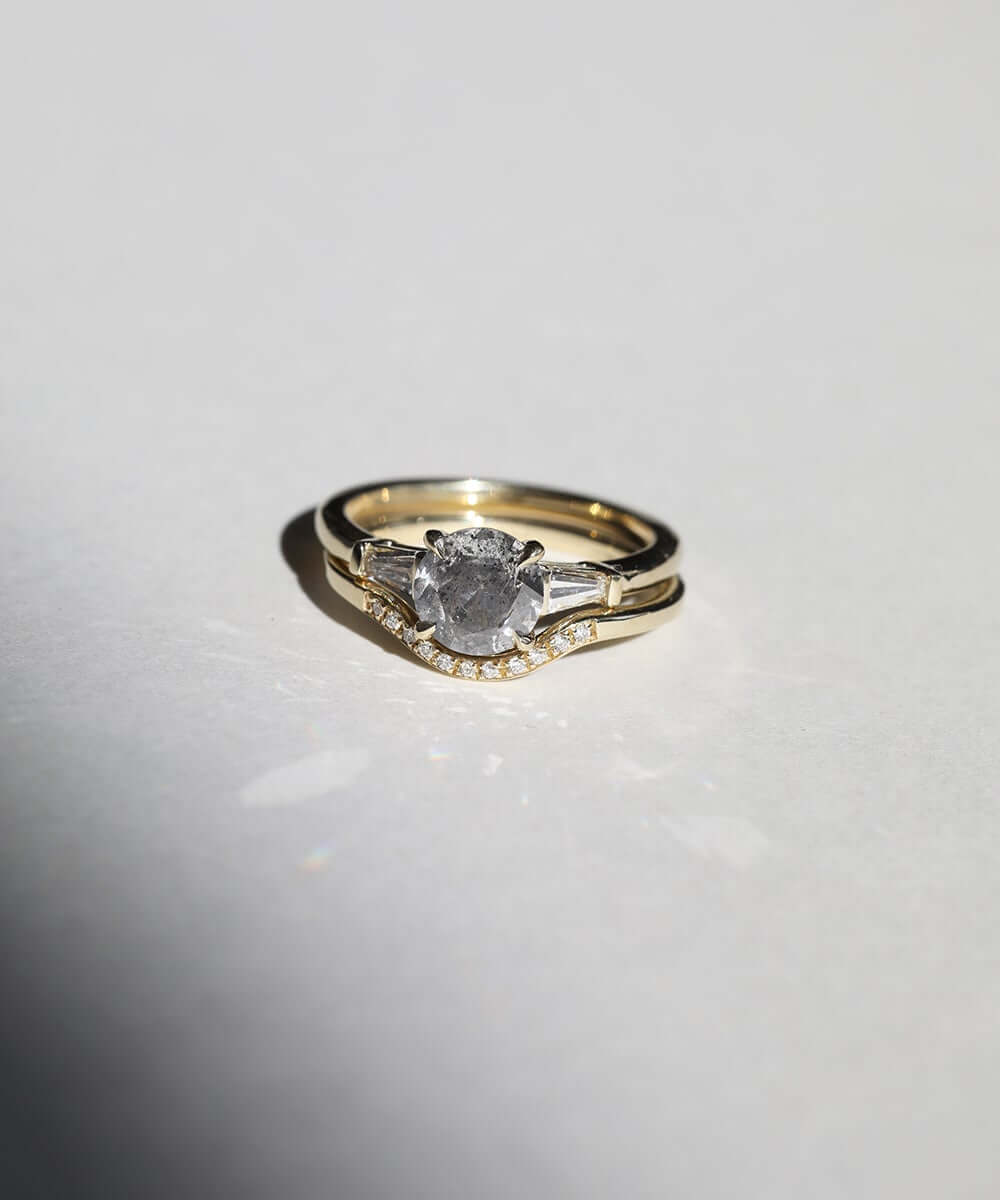 semi-translucent salt n pepper diamond engagement ring accented by white tapered baguettes set in 14k gold band macha studio brooklyn new york