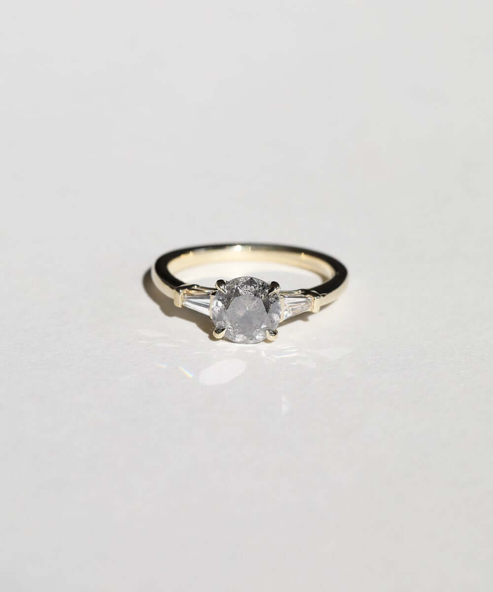 semi-translucent salt n pepper diamond engagement ring accented by white tapered baguettes set in 14k gold band macha studio brooklyn new york