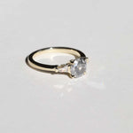 semi-translucent salt n pepper diamond engagement ring accented by white tapered baguettes set in 14k gold band macha studio brooklyn new york