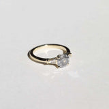 semi-translucent salt n pepper diamond engagement ring accented by white tapered baguettes set in 14k gold band macha studio brooklyn new york