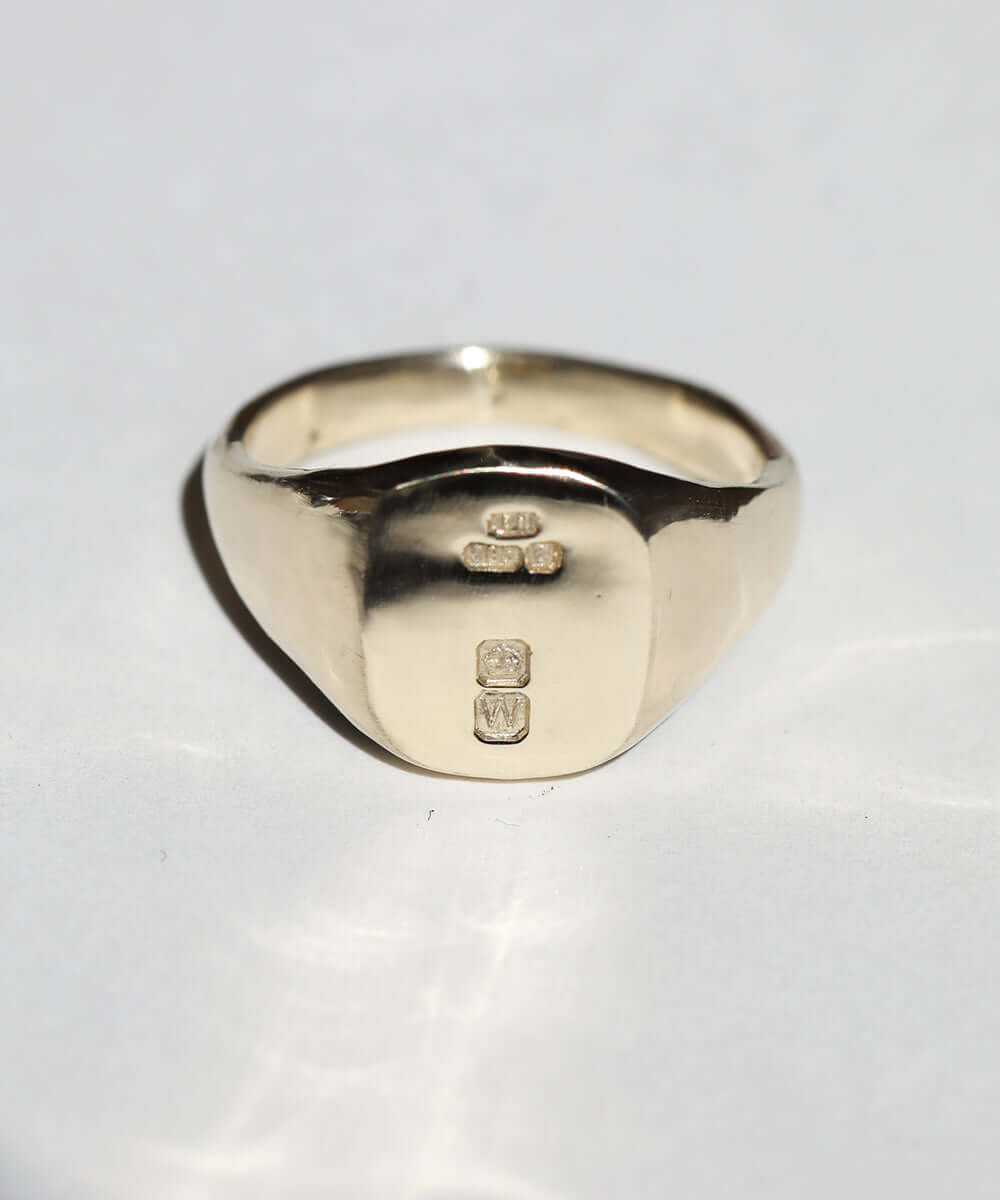 small 14k yellow gold signet ring with rounded square face featuring British hallmarks and date letter 'w' handcrafted macha studio brooklyn new york