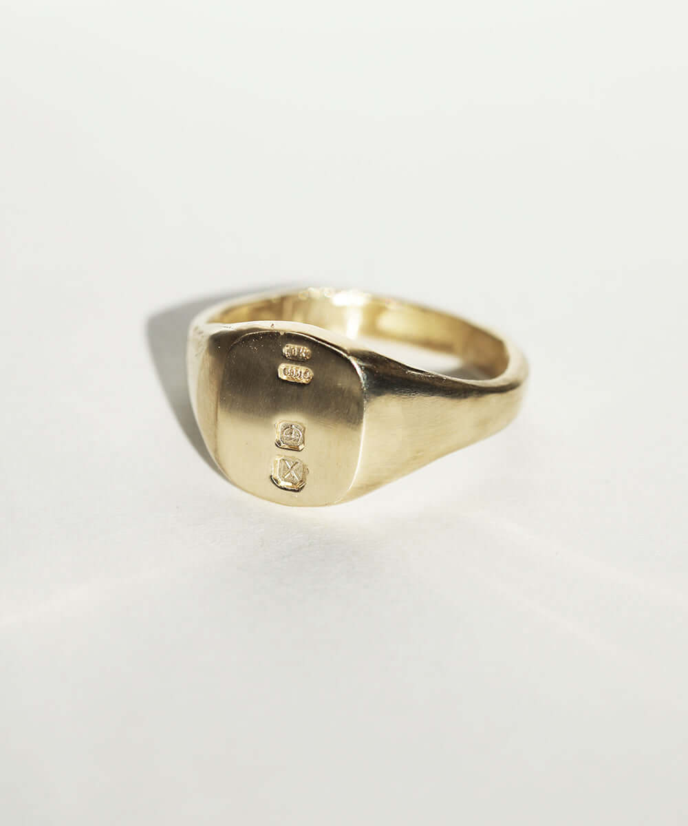 small 14k yellow gold signet ring with rounded square face featuring British hallmarks and date letter 'w' handcrafted macha studio brooklyn new york